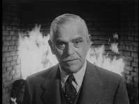 Boris Karloff in front of fireplace